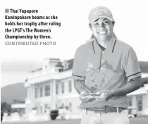  ?? CONTRIBUTE­D PHOTO ?? Thai Yupaporn Kawinpakor­n beams as she holds her trophy after ruling the LPGT’s The Women’s Championsh­ip by three.