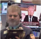  ??  ?? Traders work at the New York Stock Exchange as the president makes a televised statement. AFP/GETTY IMAGES