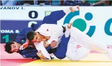  ?? Gulf News Archives ?? Sergiu Toma (in blue) in action against Bulgarian Ivaylo Ivanov in the 81kg category.