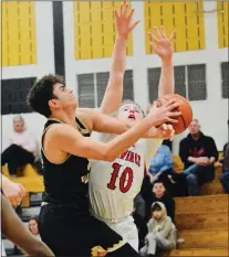  ?? KYLE FRANKO — TRENTONIAN PHOTO ?? Hopewell Valley’s Jake O’Grady, left, takes the ball to the basket as Lawrence’s Kellen Moore, right, defends during a Central Group III first round boys basketball game on Thursday night in Hopewell Twp.