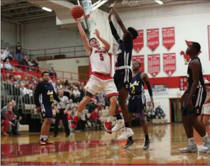  ?? TIM PHILLIS — FOR THE NEWS-HERALD ?? Mentor’s Luke Floriea drives into the lane against Euclid’s Mario Lacy Jr. on Jan. 8.