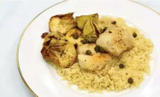  ?? KARON LIU/TORONTO STAR ?? Couscous helps to soak up the brown-butter drizzle on top of the charred canned artichokes.