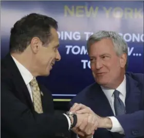  ?? AP PHOTO/BEBETO MATTHEWS, FILE ?? In this Nov. 13, 2018 file photo, New York Gov. Andrew Cuomo, left, and New York City Mayor Bill de Blasio shake hands during a news conference in New York. Cuomo and de Blasio trumpeted Amazon’s decision to build a $2.5 billion campus in the Queens borough of New York as a major coup. Neither one expected the near immediate local backlash that would cause Amazon to cancel their plans on Thursday.