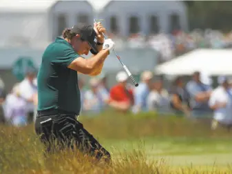  ?? Carolyn Kaster / Associated Press ?? Phil Mickelson reacts to a shot from the fescue on the fifth hole during the third round Saturday — the day he turned 48. It will be a birthday he remembers for all the wrong reasons.