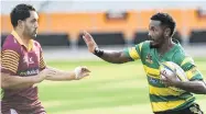  ?? PHOTO: GERARD O’BRIEN ?? Tell it to the hand . . . Green Island winger Vilimone Bainibure prepares to fend AlhambraUn­ion flanker Tyron Pelasio during their premier club game at Forsyth Barr Stadium on Saturday.