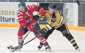 ??  ?? Dundee Comets’ Gordon Nelson battles with Tigers’ Scott Marr during the SNL match at the Dundee Ice Arena.