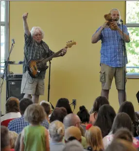  ?? (Democrat-Gazette file photo) ?? Keith Grimwood and Ezra Idlet of Trout Fishing in America perform a show for kids in 2015 at the Fayettevil­le Public Library.