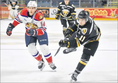  ?? T.J. COLELLO/CAPE BRETON POST ?? Tyler Hylland of the Cape Breton Screaming Eagles, right, fires a shot on goal while being watched by Jack Tucker of the Moncton Wildcats during Quebec Major Junior Hockey League action Tuesday at Centre 200. Hylland scored a goal in the game as Cape...