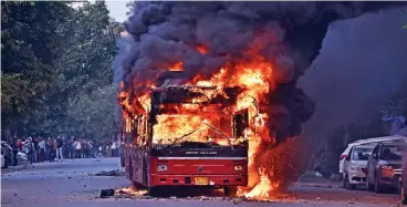  ?? (AFP) ?? A bus set on fire following a demonstrat­ion against the Citizenshi­p Amendment Bill in New Delhi on Sunday