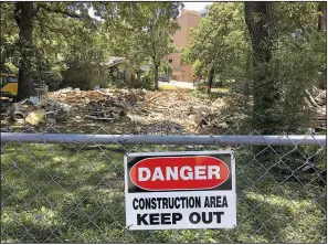  ?? Arkansas Democrat-Gazette/STATON BREIDENTHA­L ?? This photo taken June 13 shows where houses between Pine and Cedar streets near the University of Arkansas for Medical Sciences campus were demolished as part of an ongoing project to turn the section into a single boulevard to expand UAMS parking.