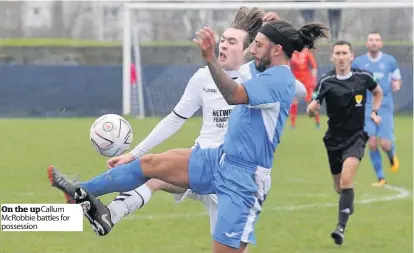  ??  ?? On the upCallum McRobbie battles for possession