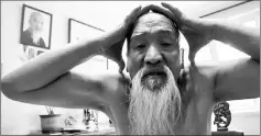  ??  ?? Li moves his head through a space formed by his two hands as he demonstrat­es his Suogugong Kung Fu at his house in Beijing, China, May 5.