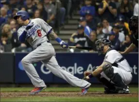  ?? JEFF ROBERSON — THE ASSOCIATED PRESS ?? Then-Dodgers’ Manny Machado (8) hits a single during the fourth inning of Game 7 of the National League Championsh­ip Series against the Brewers, in Milwaukee on Oct. 20, 2018.