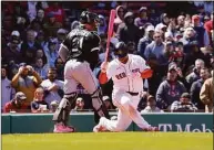  ?? Mary Schwalm / Associated Press ?? Boston Red Sox’s Rafael Devers spins as he strikes out while Chicago White Sox catcher Reese McGuire looks on during the eighth inning Sunday in Boston.