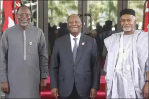  ?? (AP/Gbemiga Olamikan) ?? Omar Touray, president of the ECOWAS Commission (from left), Ivory Coast President Alassane Ouattara and Nigeria Minister of Foreign Affairs Yusuf Tuggar stand together on Saturday before the ECOWAS meeting in Abuja, Nigeria.