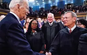  ?? SHAWN THEW/POOL VIA USA TODAY ?? President Joe Biden greets Chief Justice John Roberts on March 7 at the State of the Union address.