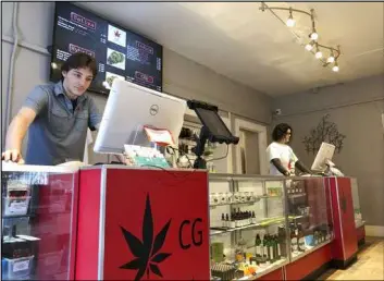  ?? Morgan Lee The Associated Press file ?? Korbin Osborn, left, works as a cannabis adviser at a medical marijuana dispensary in Santa Fe, N.M. A legislativ­e plan would legalize recreation­al pot in the state.