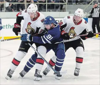  ?? GEOFF ROBINS THE CANADIAN PRESS ?? Toronto Maple Leafs’ John Tavares, centre, is checked by Ottawa Senators’ Logan Brown. left, and Ryan Dzingel during the second period of an NHL pre-season game in Lucan, Ont., on Tuesday night.