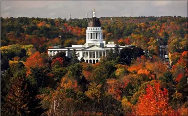  ?? ROBERT F. BUKATY — THE ASSOCIATED PRESS FILE ?? The State House is surrounded by fall foliage in Augusta, Maine, on Oct. 23, 2017. Recent leaf-peeping seasons have been disrupted by weather conditions in New England, New York and elsewhere.