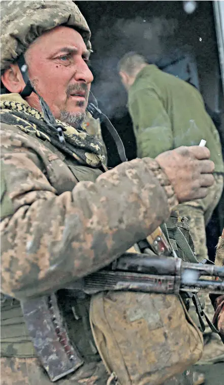  ?? ?? A wounded Ukrainian fighter recovers, right, after clashes with Russian troops and separatist­s in the city of Luhansk in the disputed Donbas region of eastern Ukraine