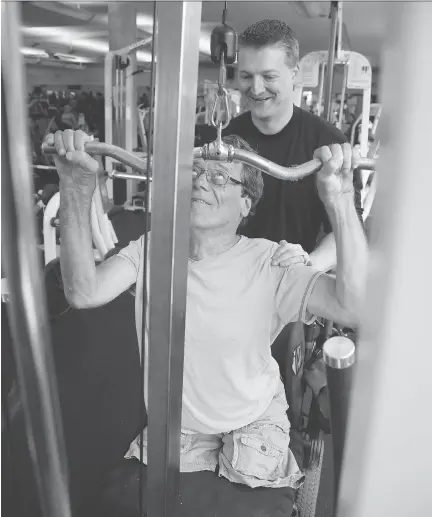  ?? JEAN LEVAC ?? Trainer Ryan Armitage works with John Woodhouse, who has dystonia and is a double leg amputee, at the Jewish Community Centre in Ottawa.