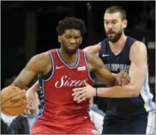  ?? BRANDON DILL — THE ASSOCIATED PRESS ?? 76ers center Joel Embiid, left, controls the ball against Grizzlies center Marc Gasol in the first half of Monday’s game in Memphis, Tenn.