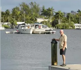  ?? PHOTOS MIKE STOCKER/SOUTH FLORIDA SUN SENTINEL ?? Terry Cantrell stands on a dock at the Hollywood Marina, looking over some of the boats anchored on North Lake in mid-December.