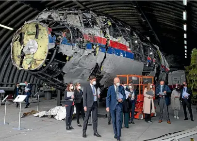  ?? AP ?? Judges and lawyers view the reconstruc­ted wreckage of Malaysia Airlines Flight MH17, at the Gilze-Rijen military Airbase, southern Netherland­s.