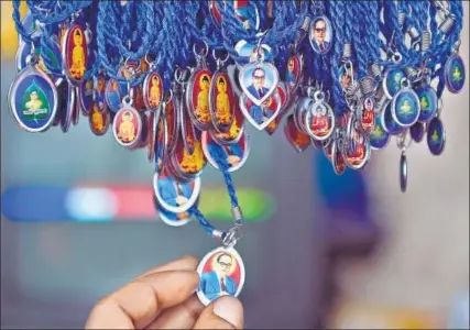  ?? AFP ?? Lockets of BR Ambedkar for sale near the Chaitya Bhoomi memorial in Mumbai.