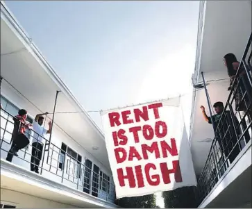  ?? Katie Falkenberg Los Angeles Times ?? MEMBERS of Housing Long Beach, which advocates for rent control, make a statement in June at an apartment complex on Cedar Avenue. More than half of California renters spend at least 30% of income on housing.