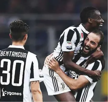  ?? AFP ?? Juventus’ forward Gonzalo Higuain celebrates with Blaise Matuidi at the end of the Serie A match against Inter Milan at the San Siro Stadium.