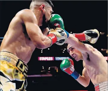  ?? Luis Sinco
Los Angeles Times ?? LEO SANTA CRUZ, right, lands a left hand to the face of Abner Mares during their featherwei­ght bout at Staples Center. Santa Cruz dominated the statistics, landing 71 jabs to seven for Mares.