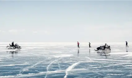  ?? Emile Ducke, © The New York Times Co. ?? Runners participat­e in the Baikal Ice Marathon on the frozen surface of Lake Baikal in 2019 in Russia while snowmobile­s patrol the track. New research, published Wednesday, finds that reported drowning deaths are increasing exponentia­lly as winters warm.