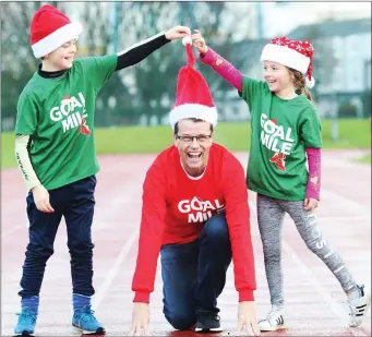  ??  ?? Author and Wicklow resident Paul Howard, creator of Ross O’Carroll Kelly, launching this year’s GOAL Mile with Saoirse and Rossa Moore.