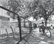  ??  ?? Denver erected a fence around the park as part of a project to restore the park’s grass, but homeless activists see the reseeding during the height of the summer as an excuse to push about 100 people out of the area.