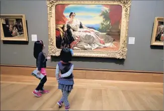  ?? Luis Sinco
Los Angeles Times ?? THE YING SISTERS Cynthia, 5, and Diana, 7, of Shanghai ponder the Getty’s classical works.