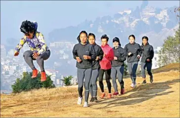  ?? AFP ?? Nepal’s athlete Mira Rai (left) takes part in a training session with other runners on a hill on the outskirts of Kathmandu on February 18.