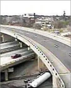  ?? PENNDOT CAMERA IMAGE ?? A tanker truck carrying propane sits on its side after overturnin­g on the ramp from the southbound Blue Route on I-95 Tuesday afternoon.