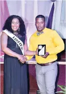  ?? CONTRIBUTE­D ?? Andrea ‘Peggy’ Lawrence accepts her award for community involvemen­t from Merrick Gayle, front office supervisor at Jewel Dunn’s River Resort