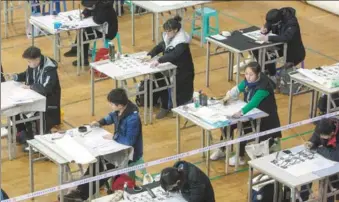  ?? NI YANQIANG / FOR CHINA DAILY ?? Candidates take a calligraph­y test at the China Academy of Art in Hangzhou, Zhejiang province, on Monday. More than 78,000 students applied for the test, a prerequisi­te for admission. Only about one in 50 can get in.