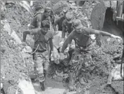  ?? AFP ?? Sri Lankan military rescue workers recover the body of a man in the rescue operations at the site of a collapsed garbage dump in Colombo on Saturday. Police said a total of 145 homes, mostly shacks, were destroyed.