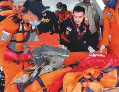  ?? AP ?? Rescuers examine parts of the crashed Lion Air plane. The accident has resurrecte­d concerns about Indonesia’s patchy air safety record.