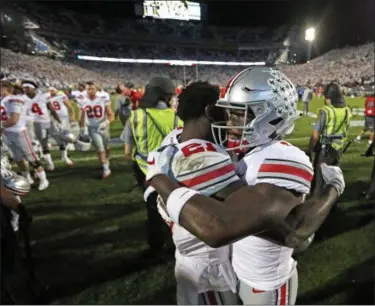  ?? CHRIS KNIGHT — THE ASSOCIATED PRESS ?? Ohio State’s Parris Campbell, left, and Johnnie Dixon embrace after beating Penn State, 27-26, in State College, Pa. on Sept. 29.