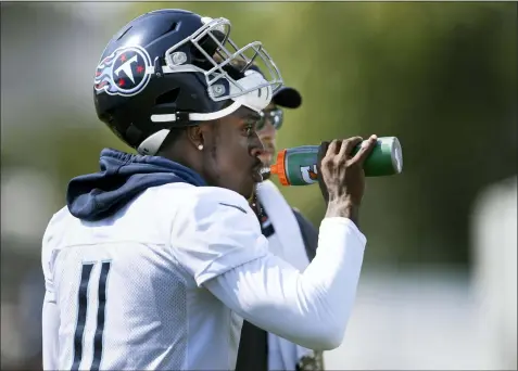  ?? GEORGE WALKER IV — THE TENNESSEAN VIA AP ?? Tennessee Titans wide receiver A.J. Brown (11) drinks water during NFL football practice at Saint Thomas Sports Park, Sunday in Nashville, Tenn.