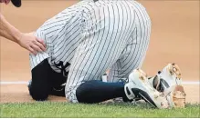  ?? NOAH MURRAY THE ASSOCIATED PRESS ?? New York Yankees' Didi Gregorius goes down after a collision with Toronto Blue Jays first baseman Kendrys Morales on Sunday.