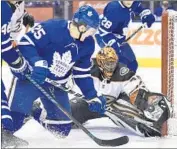  ?? Frank Gunn Associated Press ?? RYAN MILLER of the Ducks makes a save against James van Riemsdyk (25) of the Toronto Maple Leafs.