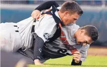  ?? TED KIRK/ASSOCIATED PRESS ?? Oregon State’s Adley Rutschman, left, and Kevin Abel celebrate after winning Game 3 of the College World Series, 5-0 over Arkansas on Thursday night in Omaha, Neb.