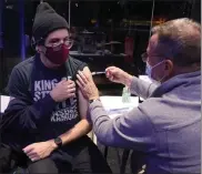  ?? NANCY LANE / BOSTON HERALD FILE ?? James Wilkerson gets a booster vaccine shot at a popup site at the Museum of Science on Dec. 5 in Boston.