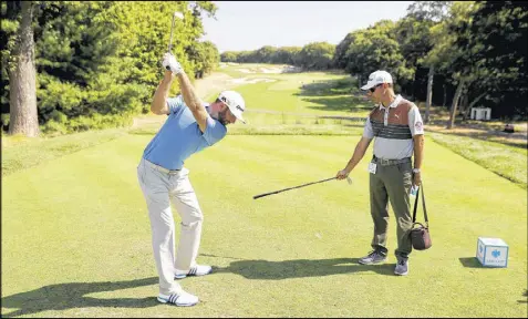  ?? DAVID CANNON / GETTY IMAGES ?? U.S. Open champ Dustin Johnson (above, working with coach Claude Harmon III during Wednesday’s pro-am at Bethpage Black) is among the favorites for PGA Tour player of the year entering the stretch run.