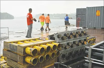  ?? Cassandra Day / Hearst Connecticu­t Media ?? Pyrotechni­cs technician­s from Bay Fireworks of Bethpage, N.Y., arrived at Harbor Park in Middletown at 4:30 a.m. on Friday with a barge full of fireworks shells from New London. Middletown fire marshals and other personnel oversaw the operation and met a truck carrying 102 boxes of fireworks just after noon.